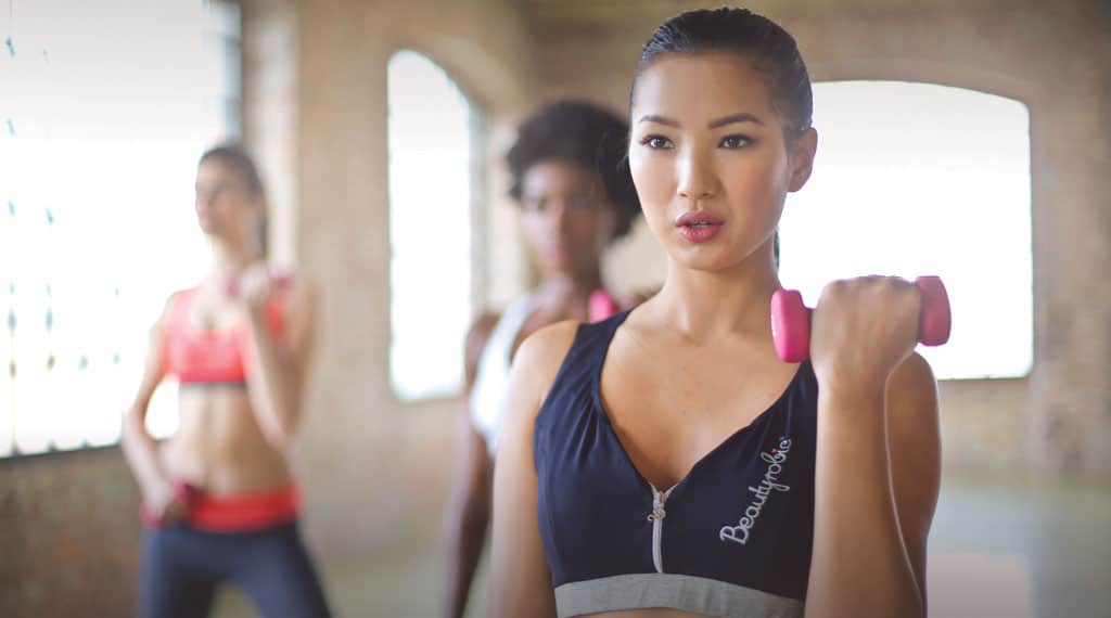 Beginner performing CrossFit exercises like squats, push-ups, and burpees with correct form.